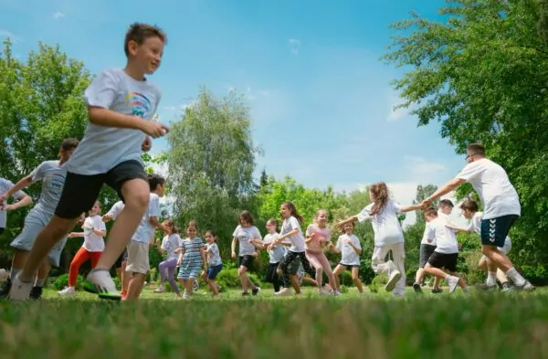 a group of young people playing a game of frisbee