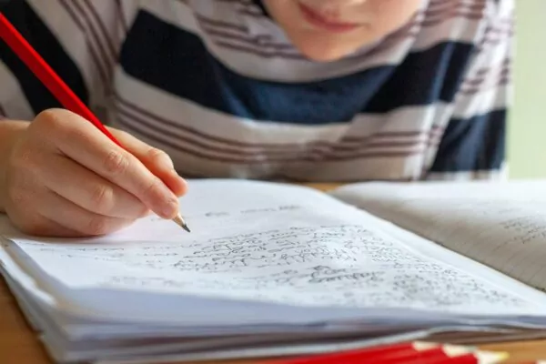 person writing on white paper