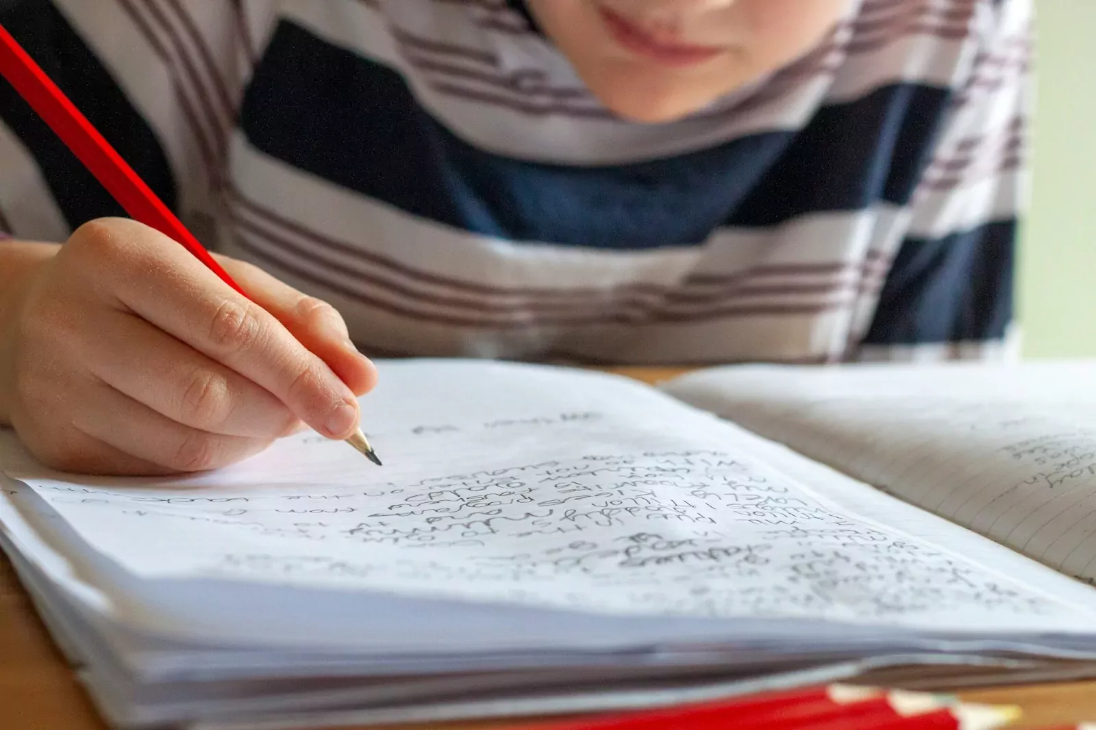 person writing on white paper